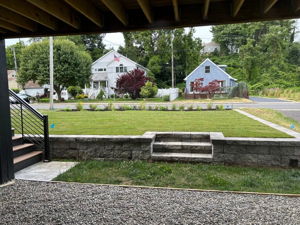 Brick retaining walls installed in a landscaped backyard in Monmouth County