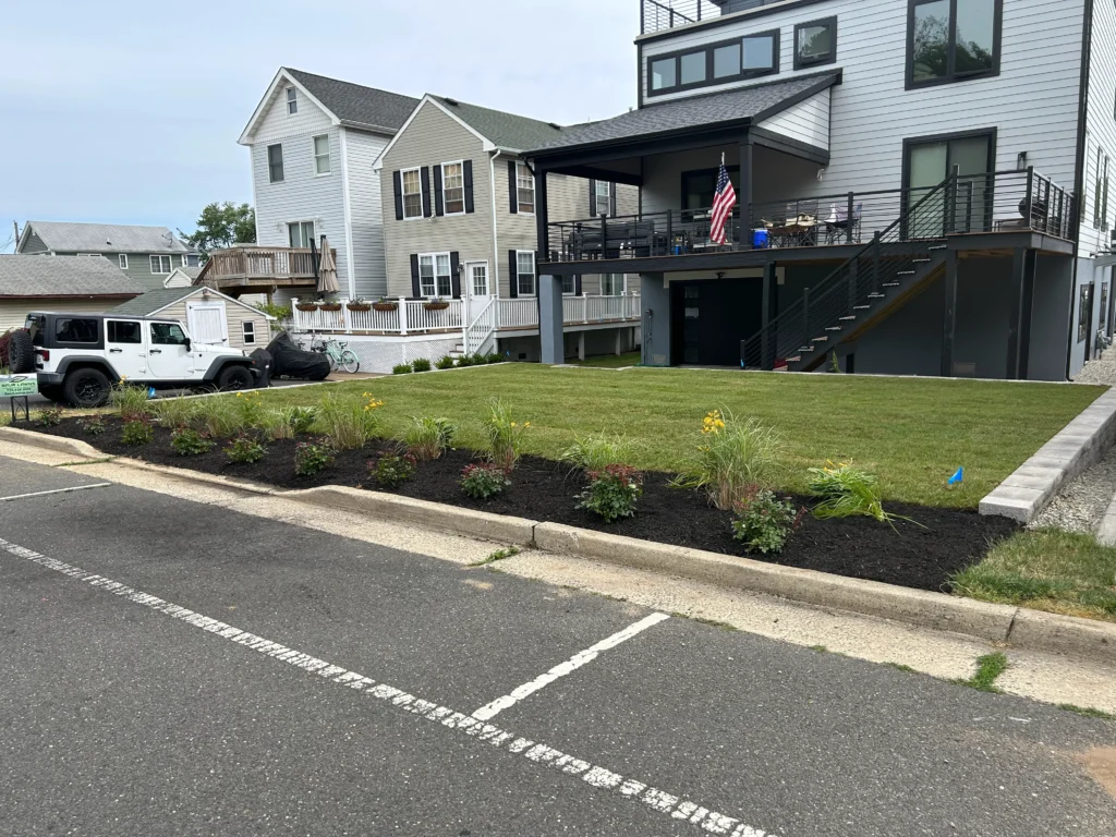 Professional commercial landscaping in Bradley Beach NJ featuring salt tolerant native buffer zones and NJ DEP compliant permeable drainage for 2026 standard coastal flood resilience and shorefront durability